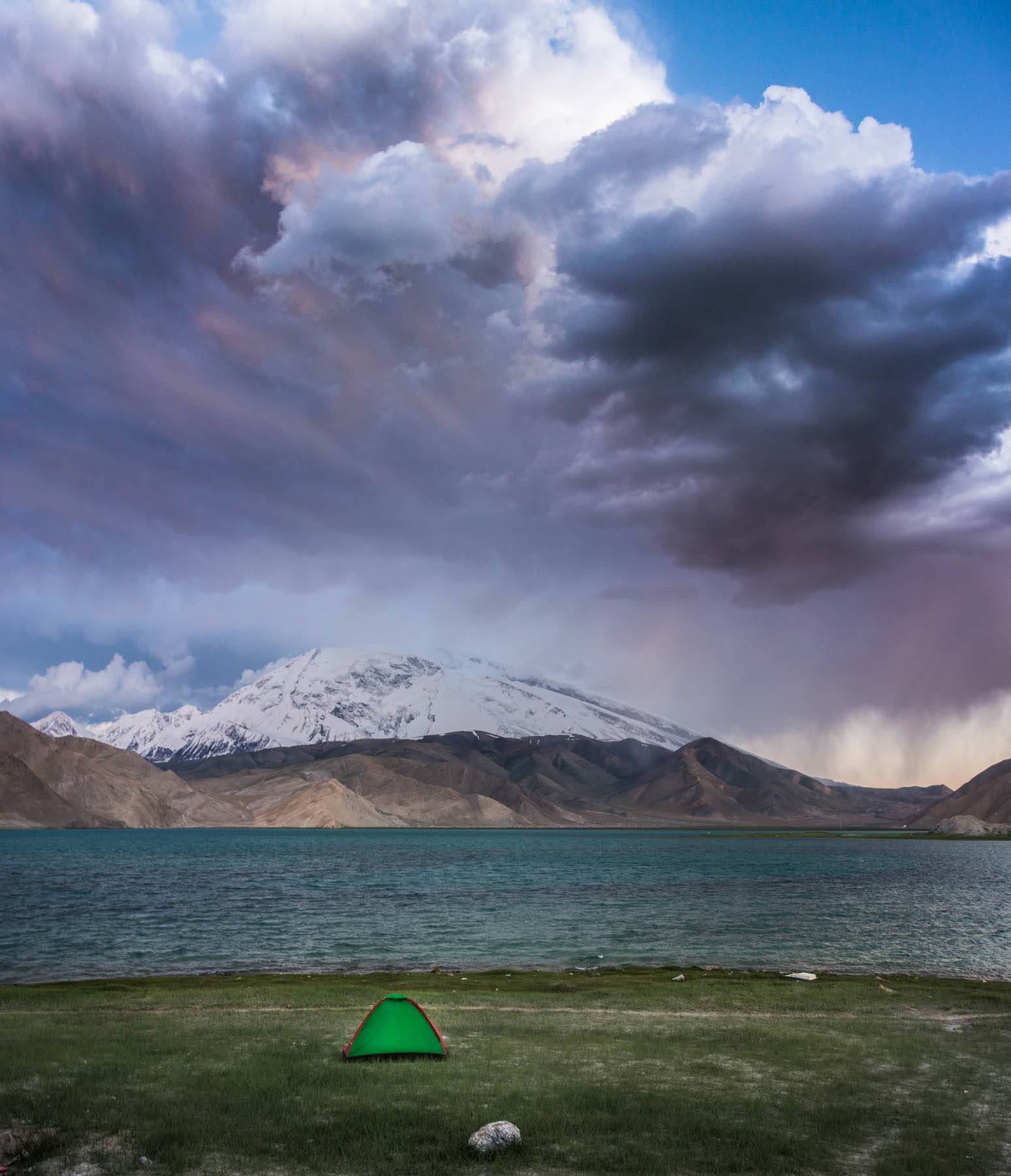Our teeny tent about to be ravaged by the elements at Karakul Lake in China.