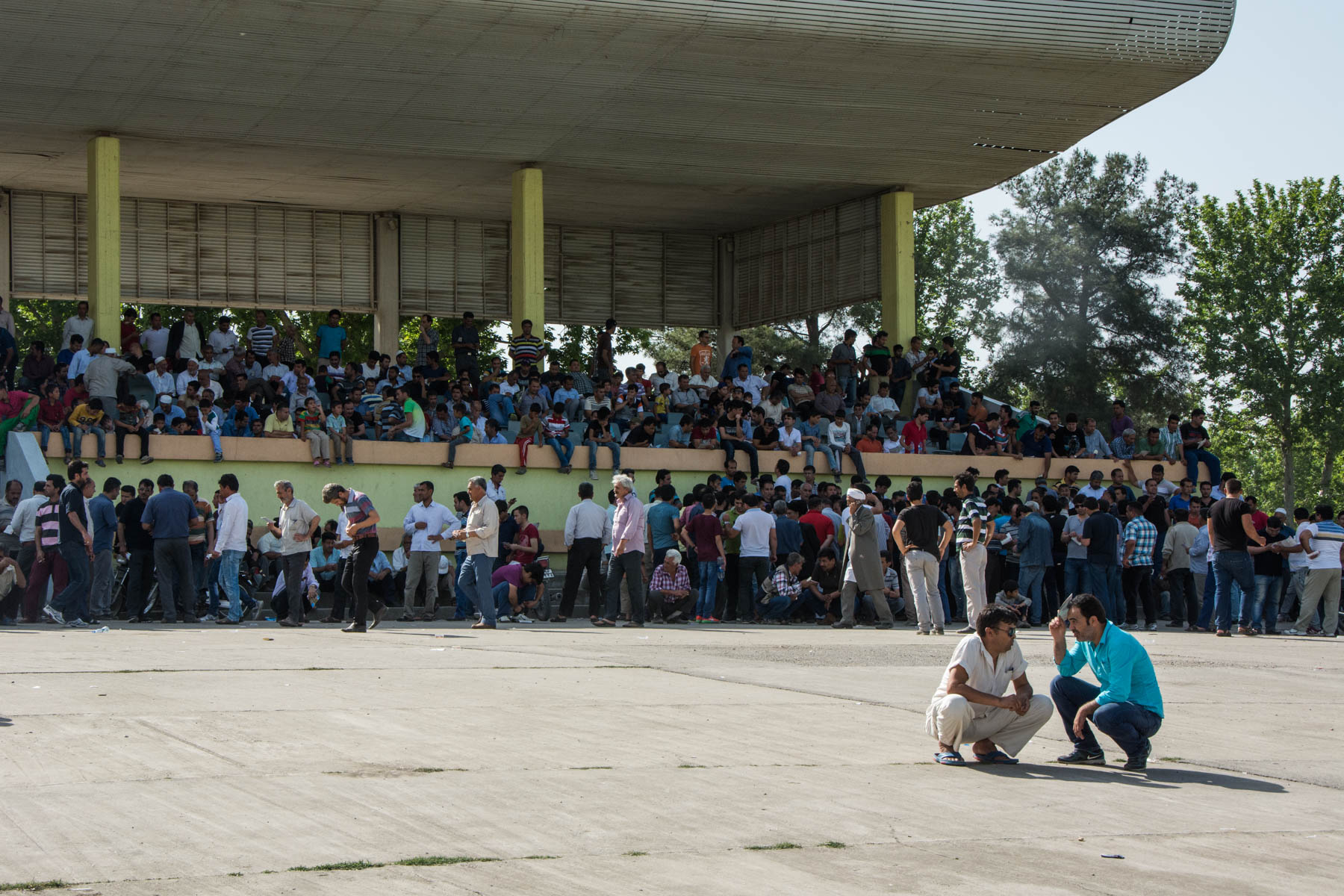 Men hiding in the shade at the horse races in Gonbad-e Kavus, Iran.