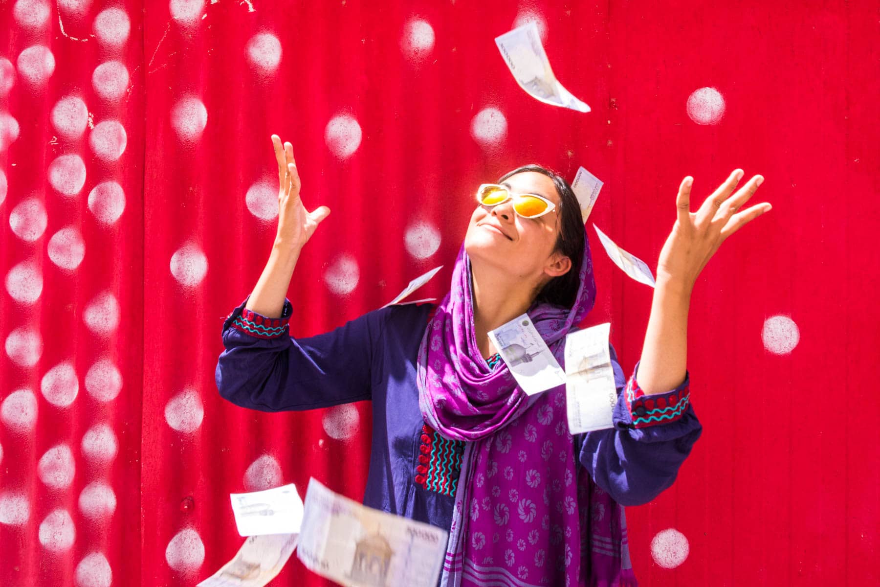 A girl throwing rial bills around