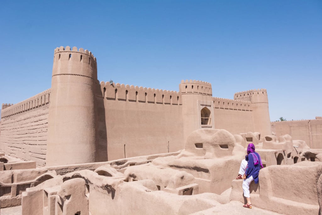 Girl sitting and checking out the view of Arg-e Rayen near Kerman.