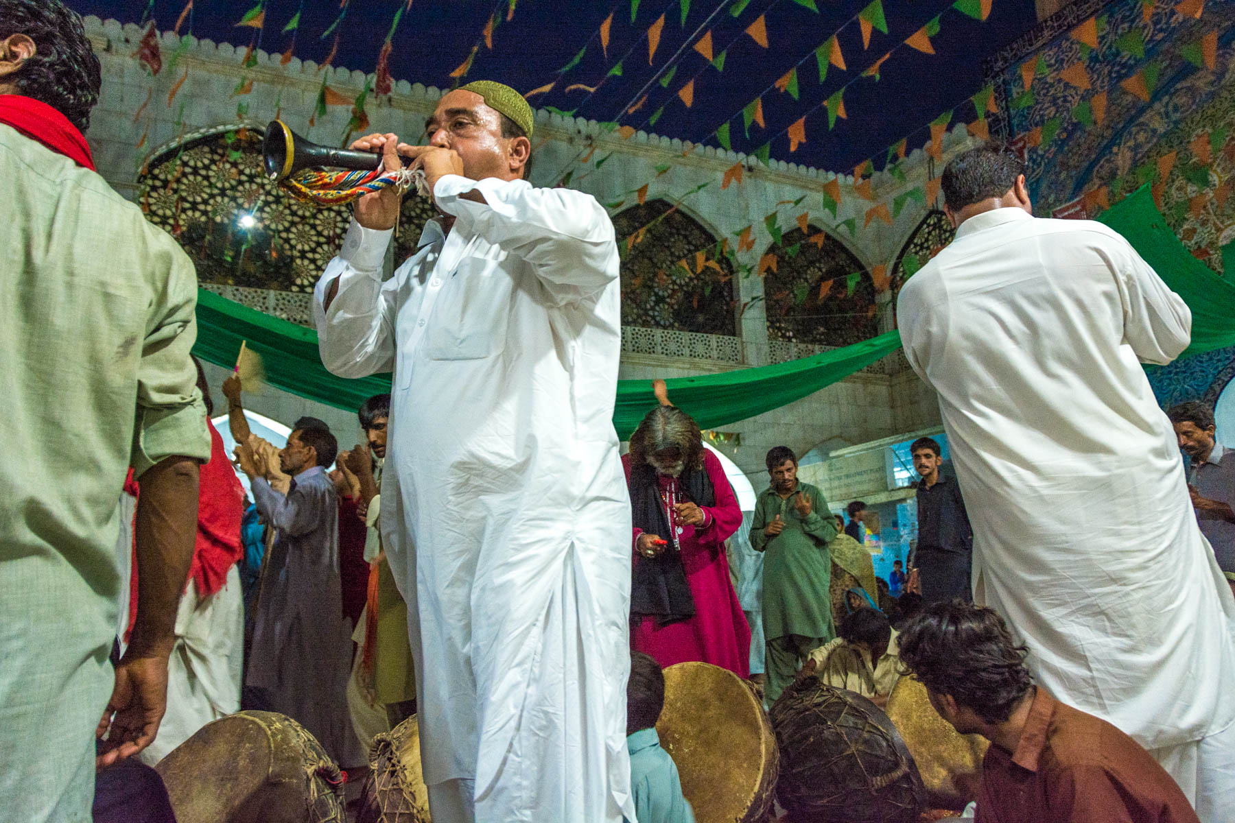 A horn player during sufi dancing at the Lal Shahbaz Qalandar shrine in Sehwan, Pakistan