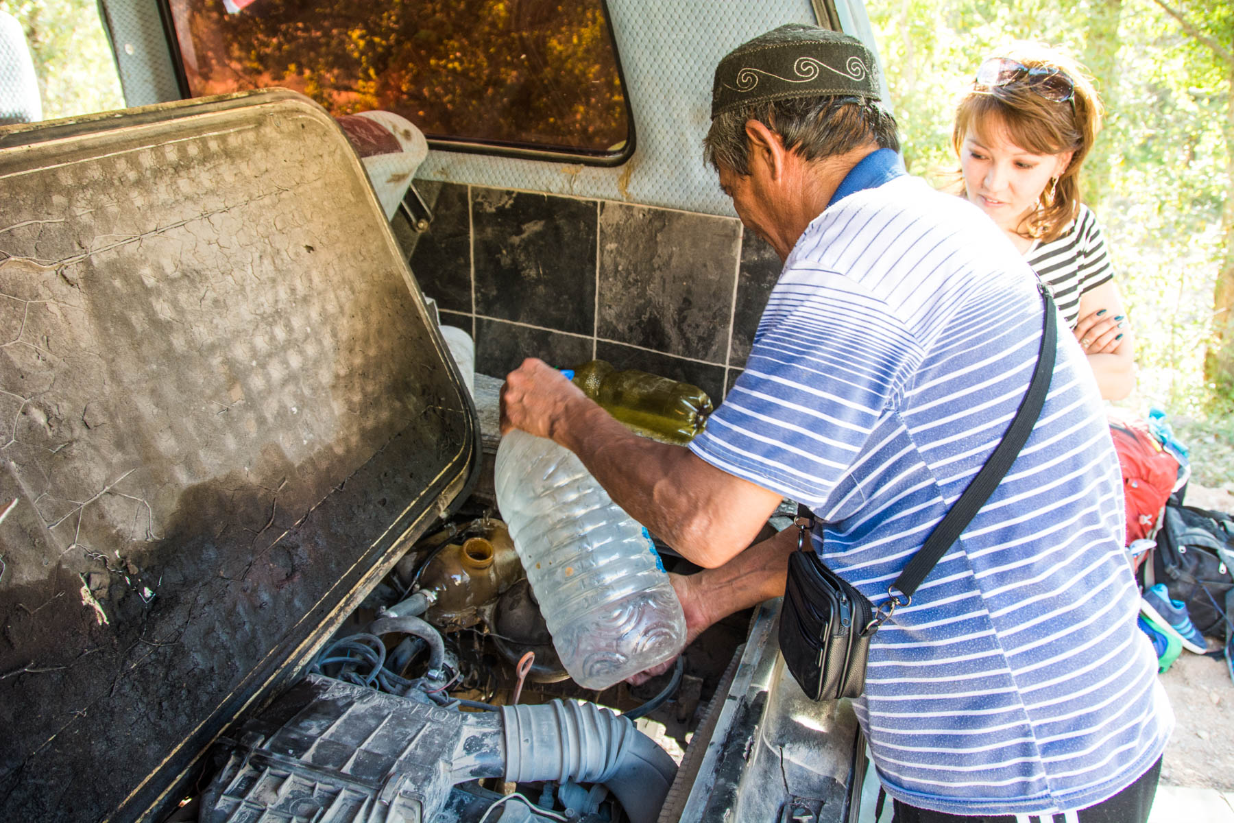 Pouring water into the van's engine on the way to Min Kush, Kyrgyzstan - Lost With Purpose