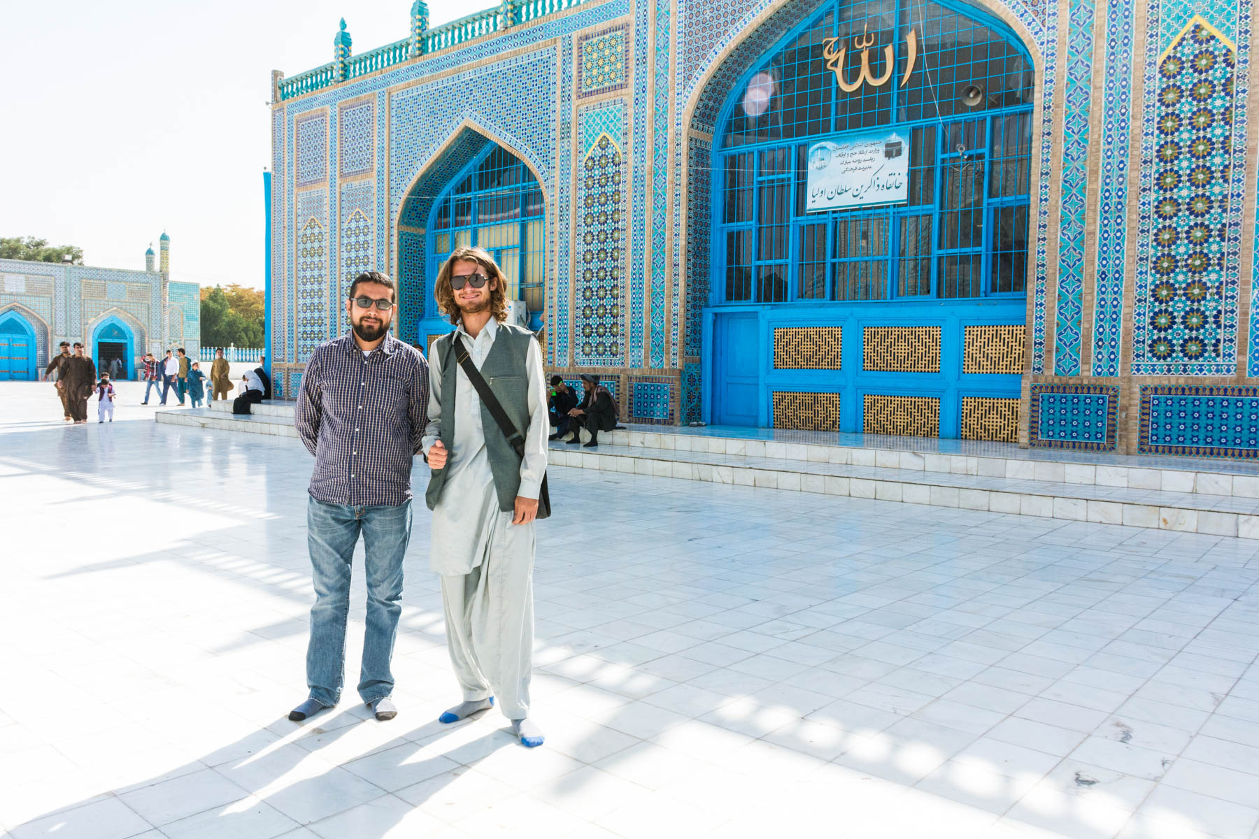 Two men standing in front of the Blue Mosque in Mazar-i-Sharif, Afghanistan