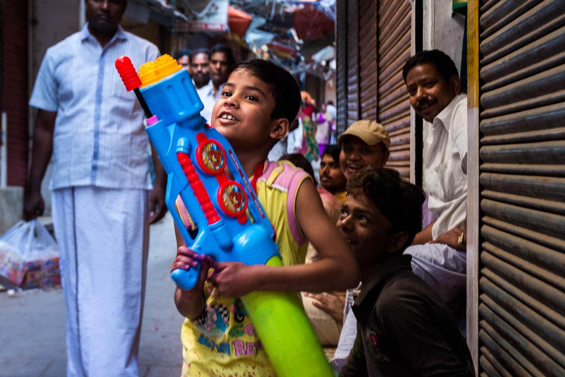 What you need know about playing Holi in Varanasi, India - A young boy with a large water gun - Lost With Purpose