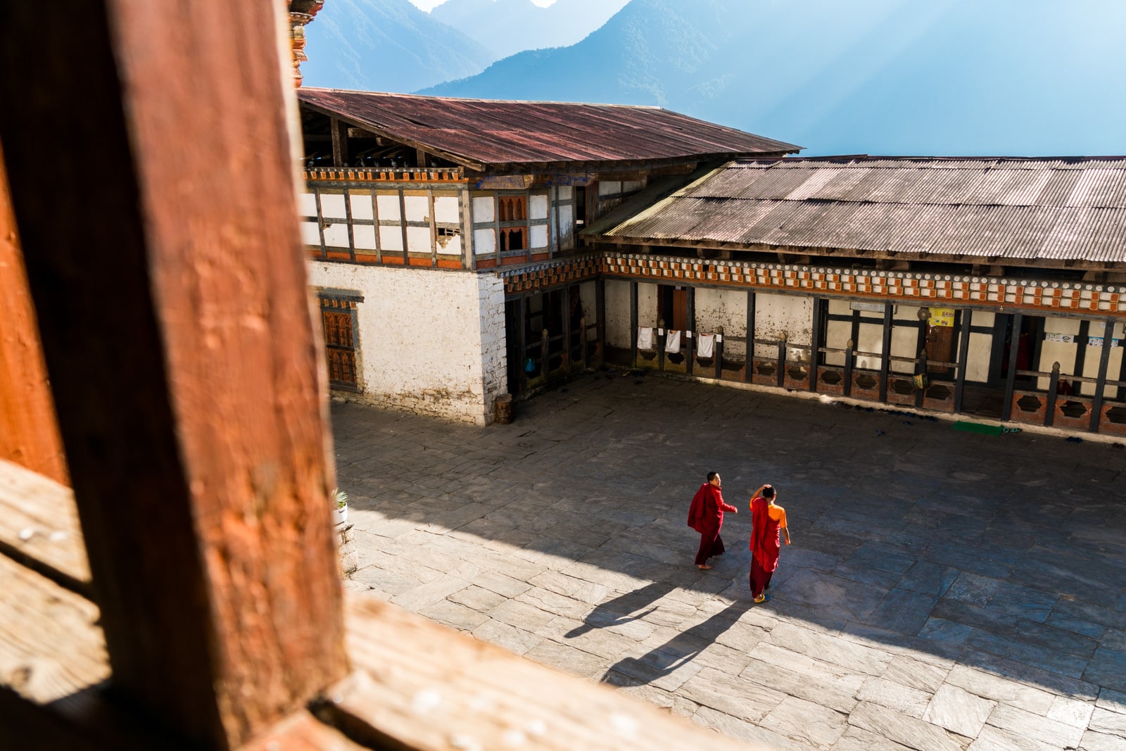 Where to go off the beaten track in Bhutan - Monks walking in Kuengarabten palace - Lost With Purpose travel blog