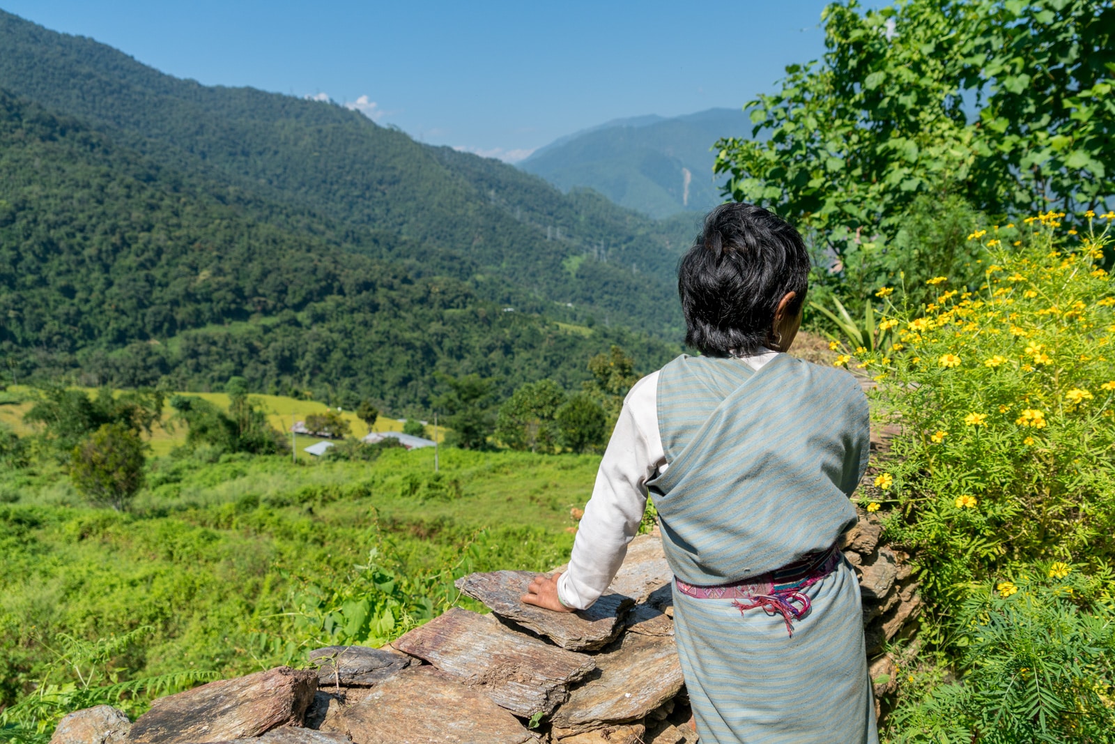 Where to go off the beaten track in Bhutan - Old woman looking downhill in Zhemgang district - Lost With Purpose travel blog