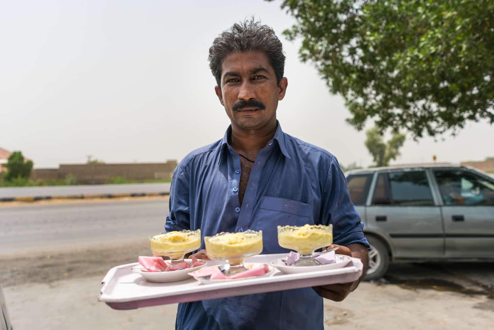 Sindh travel guide - Man serving ice cream in Matiari town - Lost With Purpose travel blog