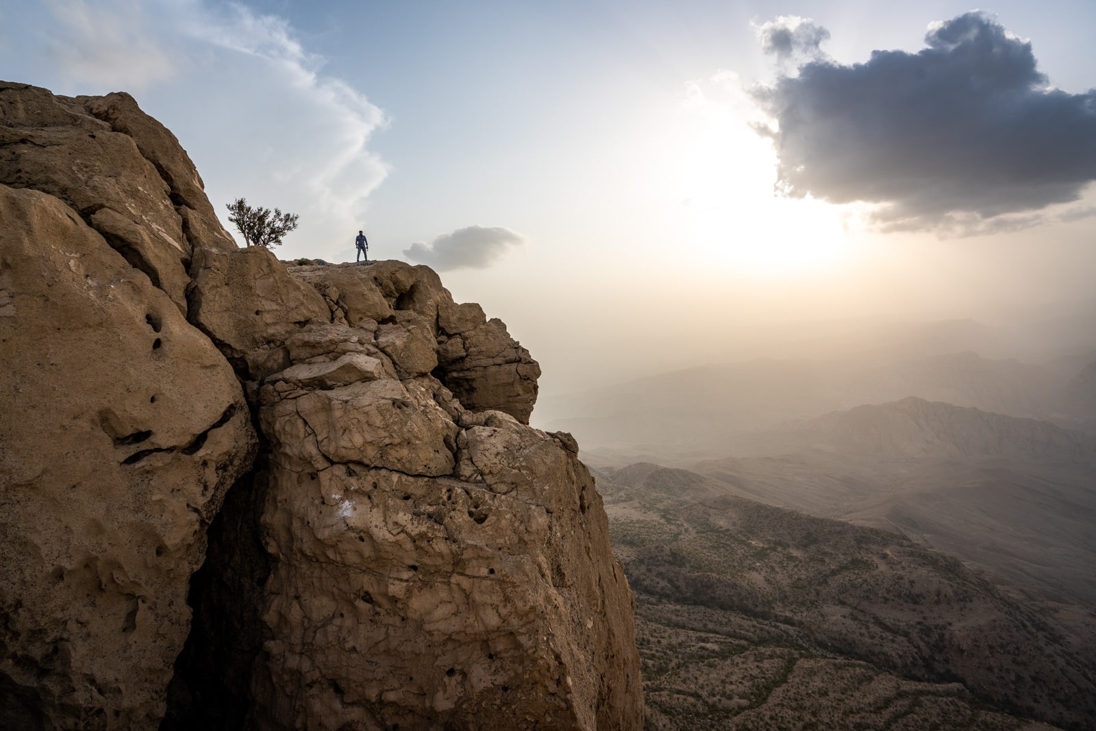 Sindh travel guide - Sunset at Gorakh Hill Station with boy standing on a cliff - Lost With Purpose travel blog