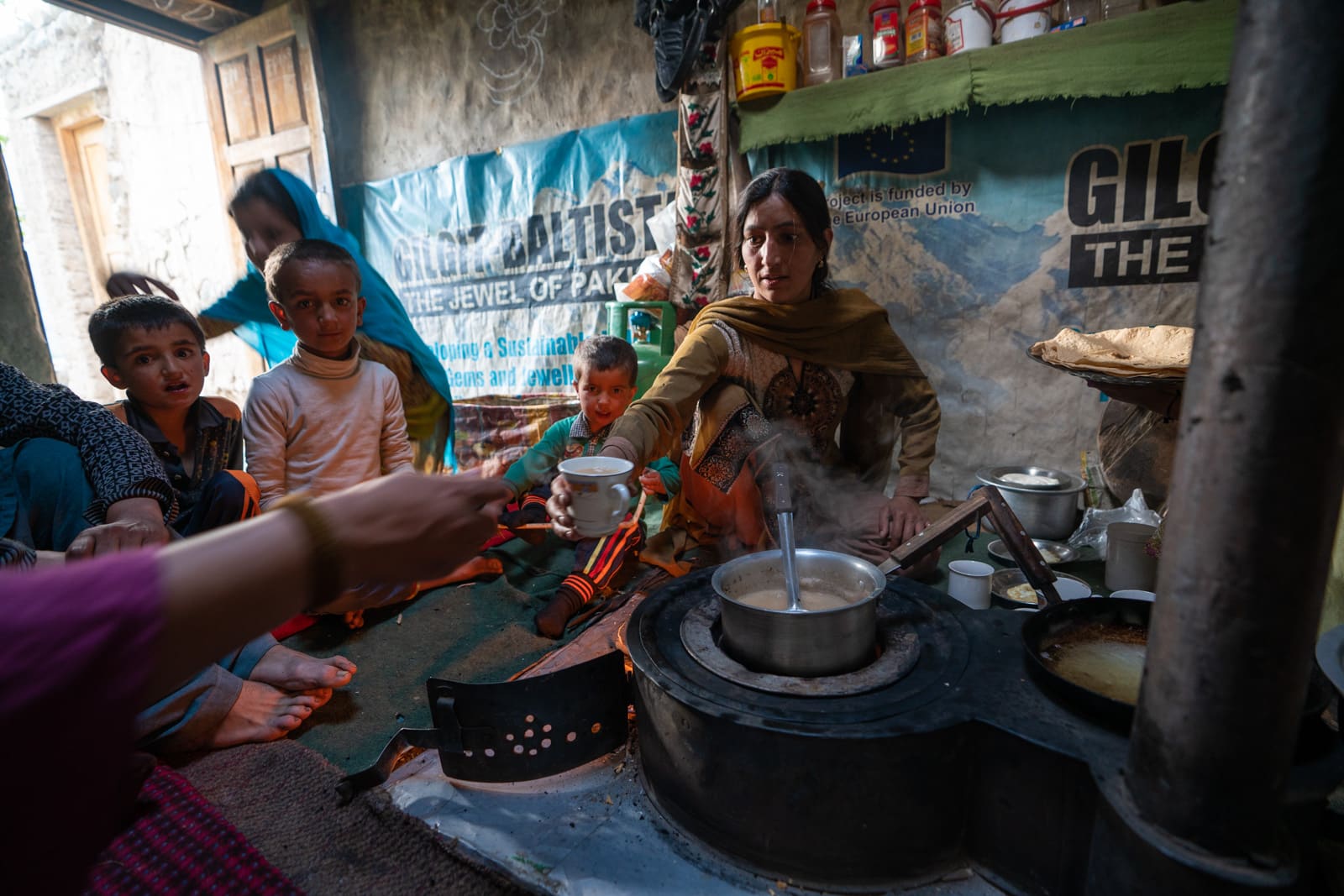 Woman serving chai in Yasin, Pakistan