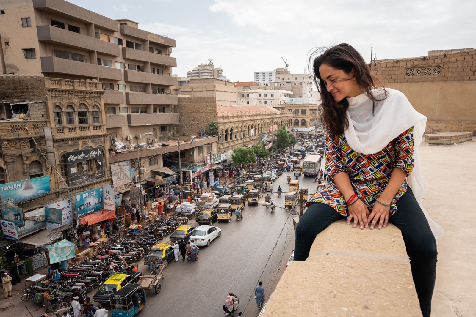 Female traveler overlooking streets of Karachi