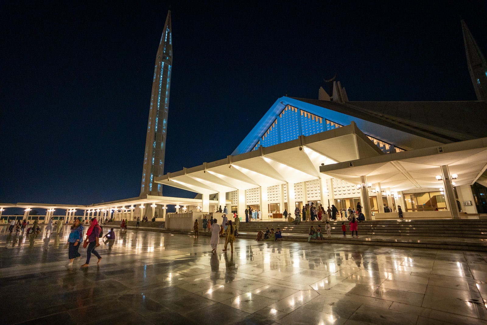 People sitting at Faisal Mosque in Islamabad, Pakistan at night