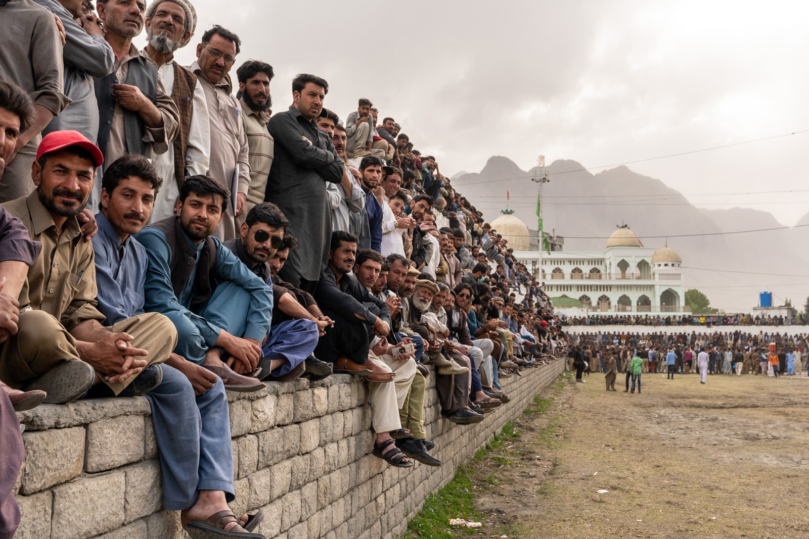 Men staring at a polo match in Gilgit, Pakistan