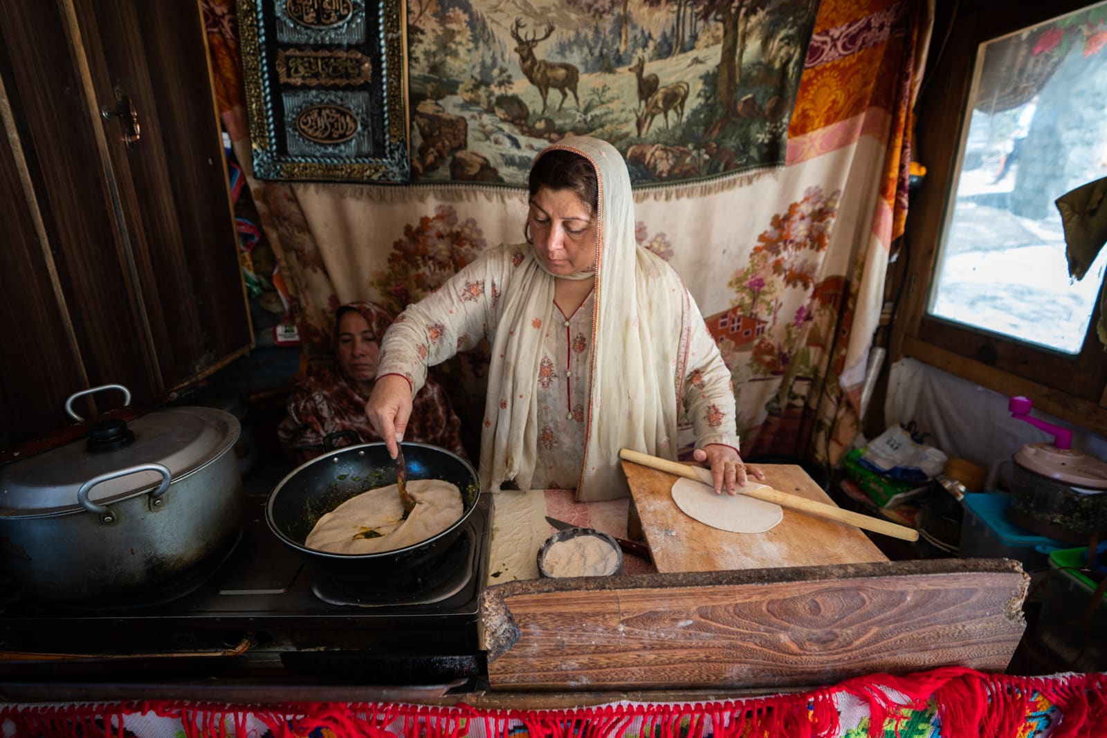 Female entrepreneur and business owner cooking at her cafe in Karimabad, Hunza, Pakistan