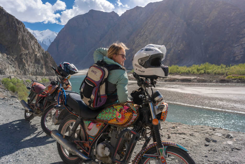 Pakistan motorcycle tour guests on the side of the Indus River in Gilgit-Baltistan, Pakistan